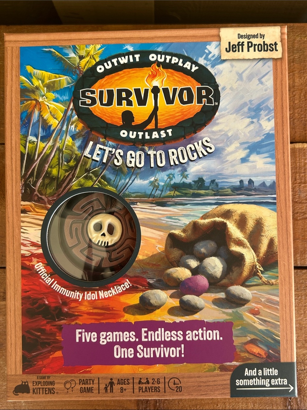 Survivor Let's Go to Rocks party game featuring included immunity idol necklace.